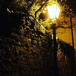 Low angle view of lamp post at night