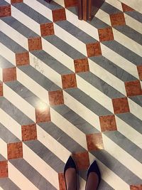 Low section of woman standing on tiled floor