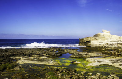 Scenic view of sea against blue sky