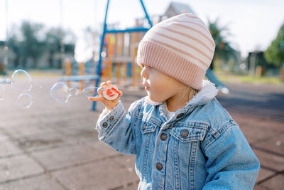 Portrait of boy blowing bubbles