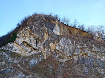 Low angle view of rock formation against sky