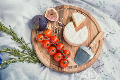 Close up round picnic cheese platter with tomatoes and figs concept photo