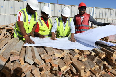 Engineers working over blueprint