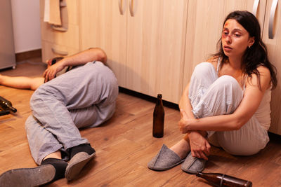 Side view of woman using mobile phone at home