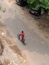 High angle view of people riding motorcycle on street