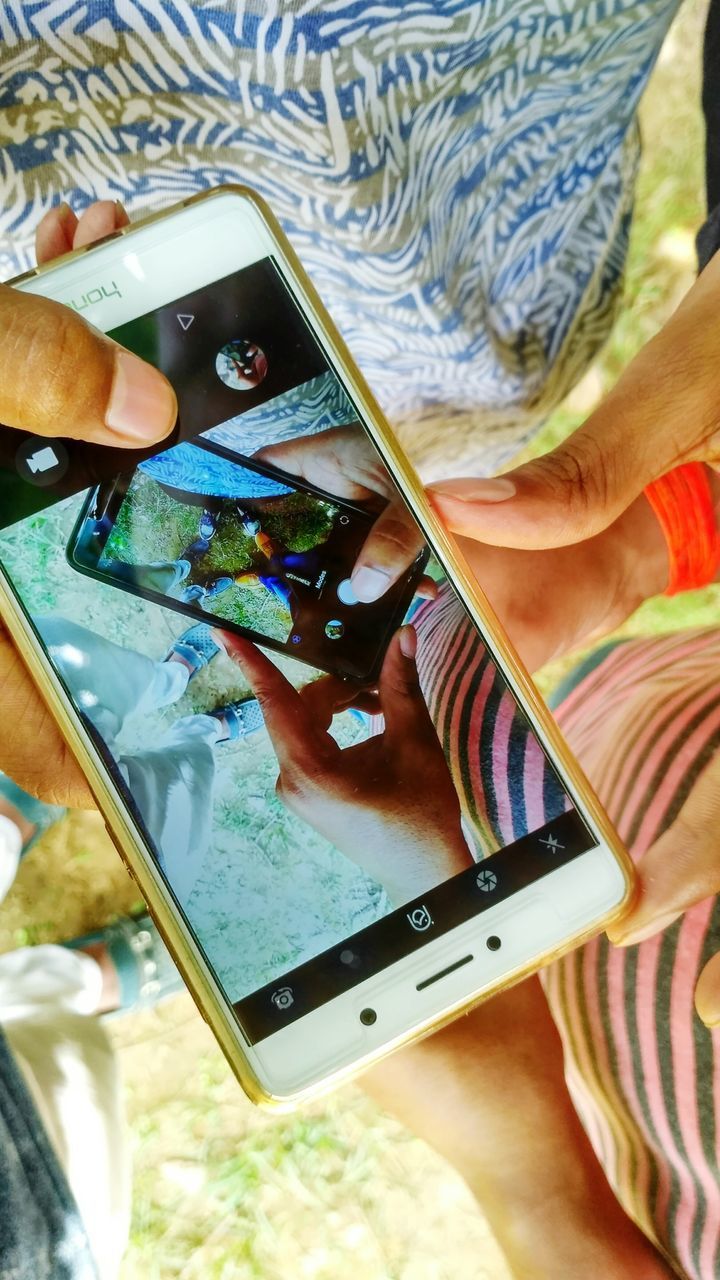 HIGH ANGLE VIEW OF WOMAN USING MOBILE PHONE