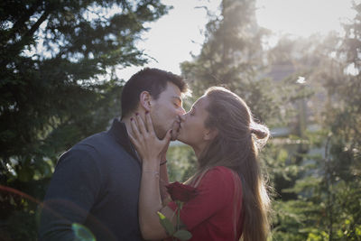 Couple kissing while standing outdoors