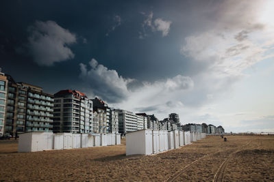 Low angle view of buildings on beach against sky