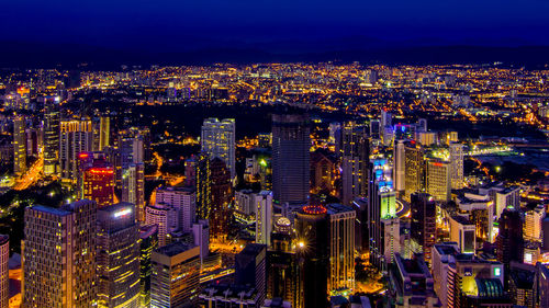 High angle view of city lit up at night