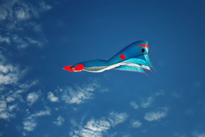 Low angle view of flag against blue sky