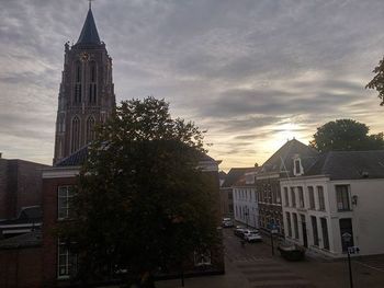 Buildings against cloudy sky