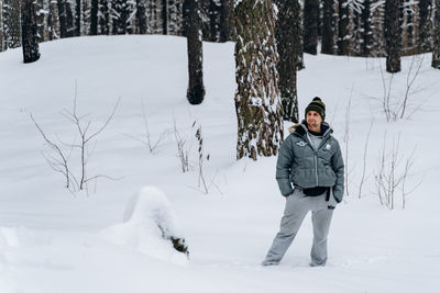 Full length of man standing on snow covered field