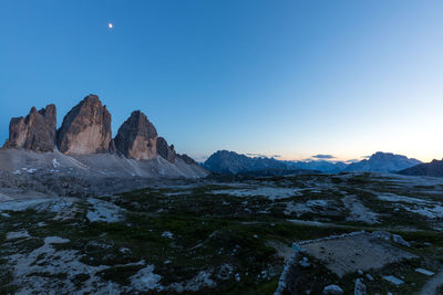 Scenic view of rocky mountains against clear blue sky