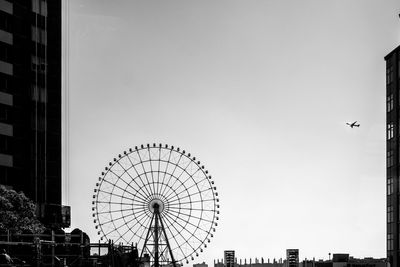Low angle view of ferris wheel against sky