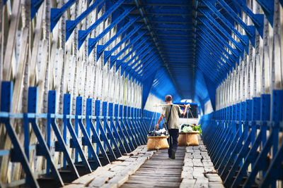 Rear view of people working on bridge