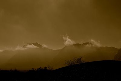 Scenic view of silhouette mountains against sky at night