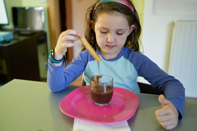 Little girl eating chocolate dessert