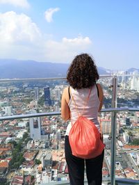 Rear view of woman looking at cityscape