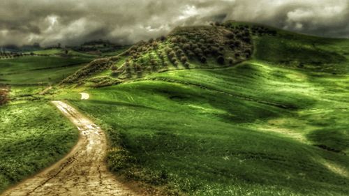 Scenic view of green landscape against sky