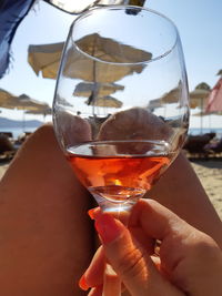 Close-up of hand holding glass of drink