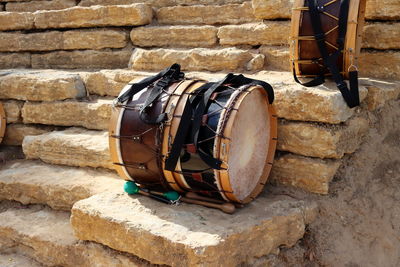 Close-up of wooden drums and sticks on a stone staircase. musical instruments on the steps  