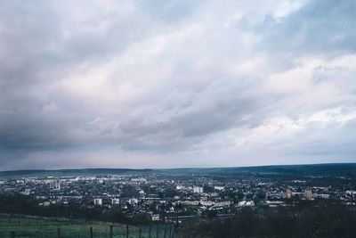 Cityscape against cloudy sky