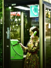 Woman looking through window