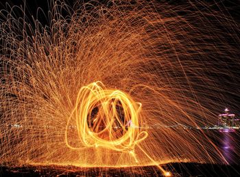 Wire wool by river at night