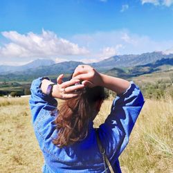 A woman who is tying her hair 