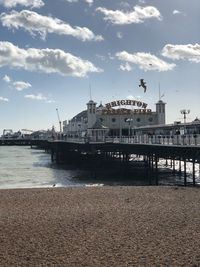 Pier by sea against sky in city