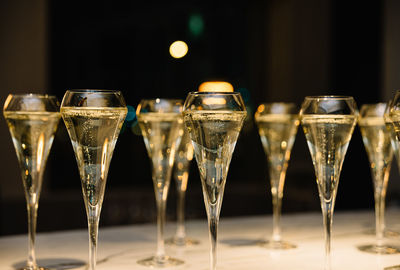 Set of champagne glasses on table top golden light bubbly fine wining in a restaurant
