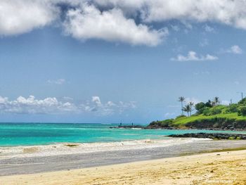 View of beach against cloudy sky