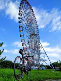 Low angle view of ferris wheel against sky