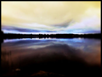 Scenic view of lake against cloudy sky