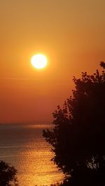 Scenic view of sea against romantic sky at sunset