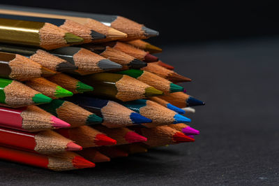 Close-up of multi colored pencils on table