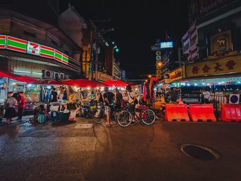 People on illuminated city street at night