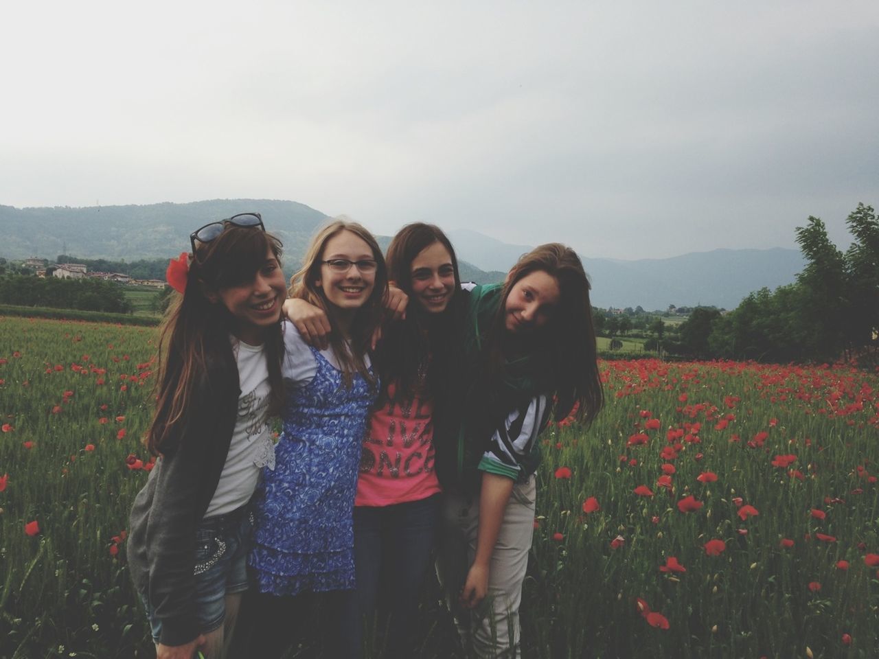 lifestyles, togetherness, bonding, leisure activity, casual clothing, field, love, standing, person, young women, friendship, family, smiling, full length, sky, young adult, three quarter length, landscape