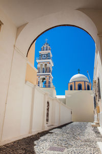 Bell tower and dome of the saint john the baptist church in the city of fira in  santorini