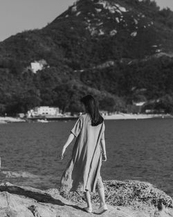 Rear view of woman looking at sea shore