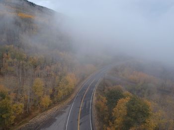 Road amidst trees during autumn