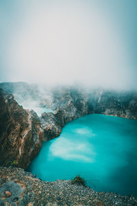 Scenic view of kelimutu lake under foggy weather