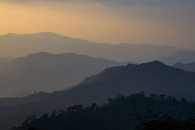 Scenic view of silhouette mountains against sky during sunset