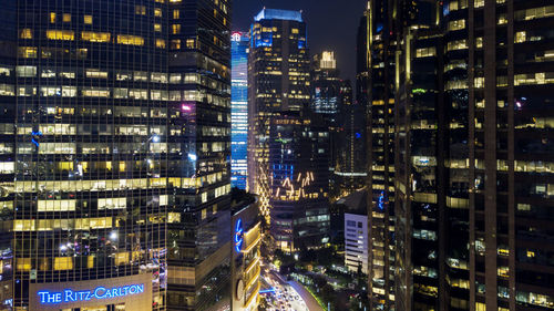 Aerial view of illuminated buildings in city at night