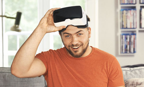 Portrait of man wearing virtual reality simulator at home