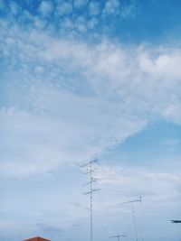 Low angle view of electricity pylon against sky