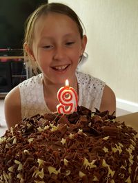 Close-up of happy girl with ice cream on table