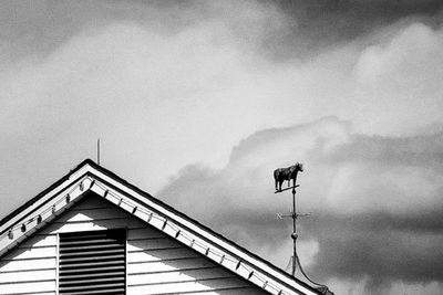 Low angle view of building against cloudy sky