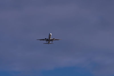 Low angle view of airplane flying in sky