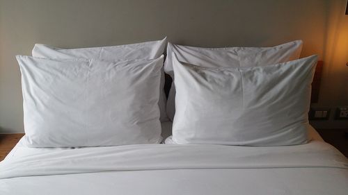 High angle view of pillows with sheet arranged on bed at home